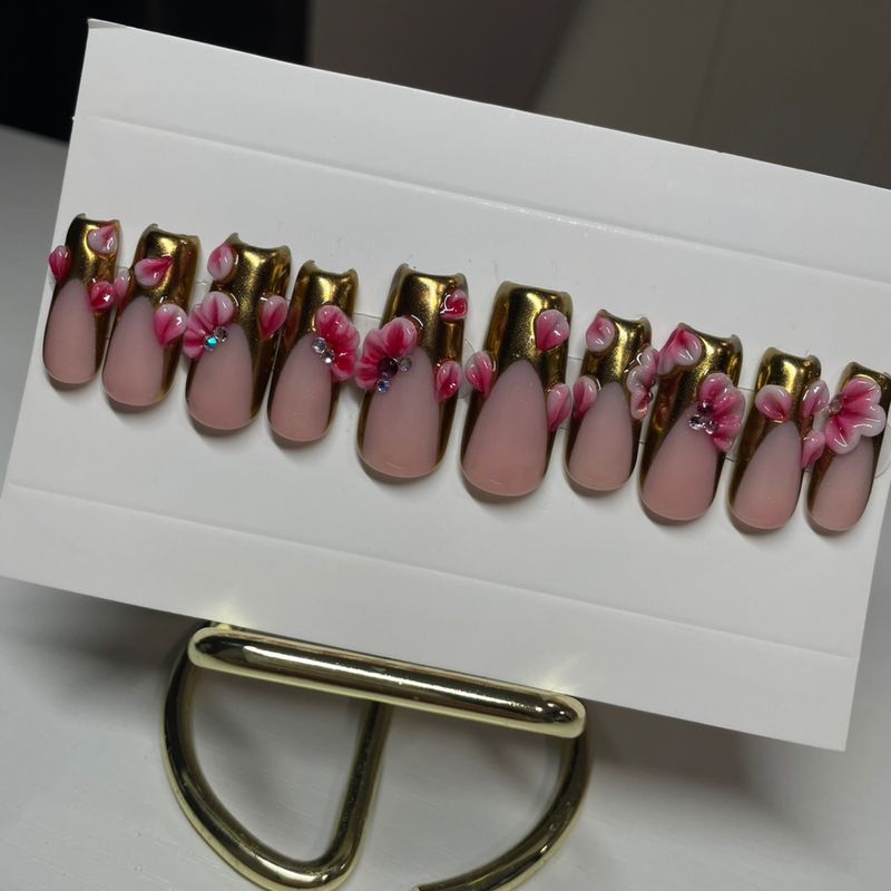 Aurelia set — long coffin press-ons with gold chrome French tips and sculpted 3D flowers.