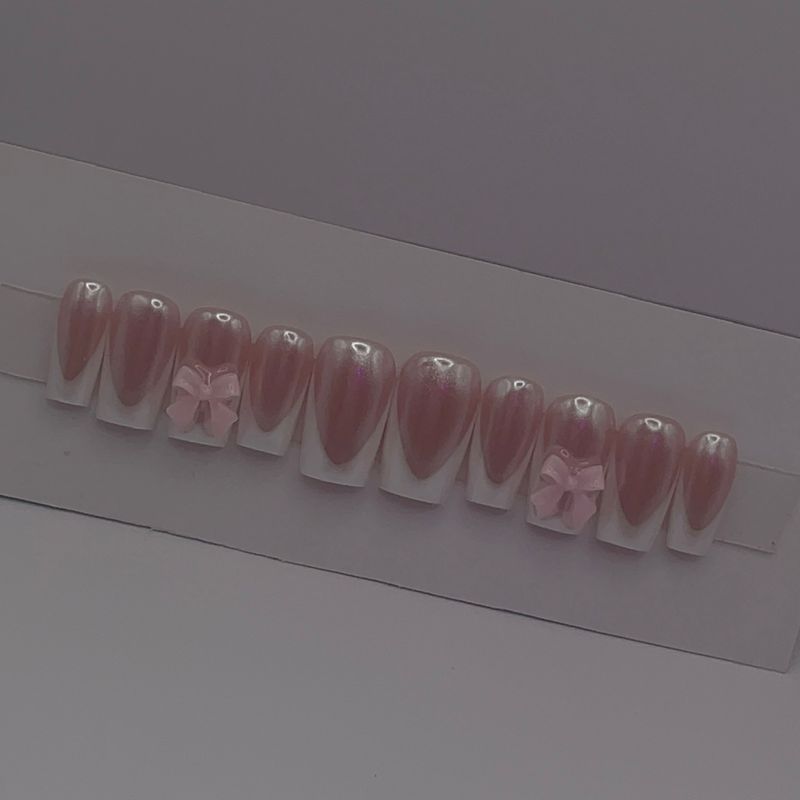 Baby Doll set — pearl-glazed pink coffin press-ons with white French tips and 3D bows.