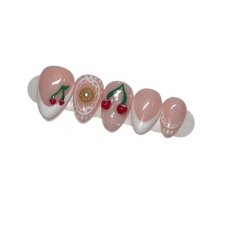Cherry Lace set — extra-short almond press-ons with white French tips, hand-painted cherries and a daisy charm.