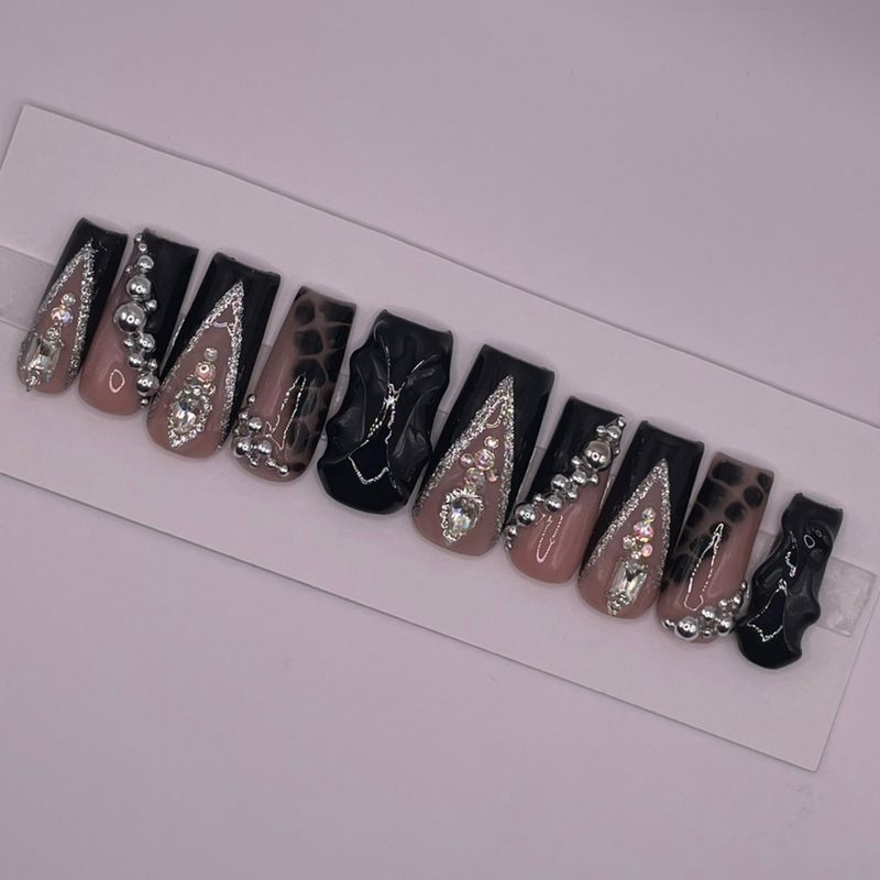Noir Obsession set — long black coffin press-ons with silver glitter French lines, chrome beads and crystals.